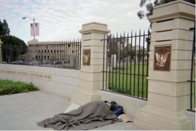 A homeless individual sleeps outside the V.A.'s West L.A. campus