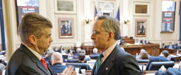 House majority leader, Del. Kirk Cox, R-Colonial heights, talks with Senate Republican floor leader, Sen. Thomas Norment, R-James City County, right during the House session at the Capitol Thursday, Feb. 21, 2013 in Richmond, Va.